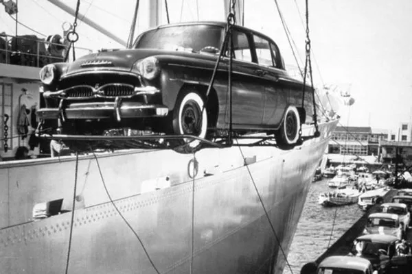 A picture of a 1st-gen Crown being unloaded from a cargo ship