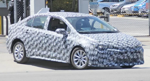 The angular front of the Toyota Corolla 2019 sedan in camouflage