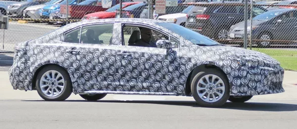 The side of the Toyota Corolla 2019 sedan in camouflage