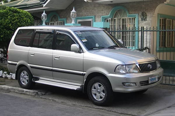 A picture of the Revo parked near a house