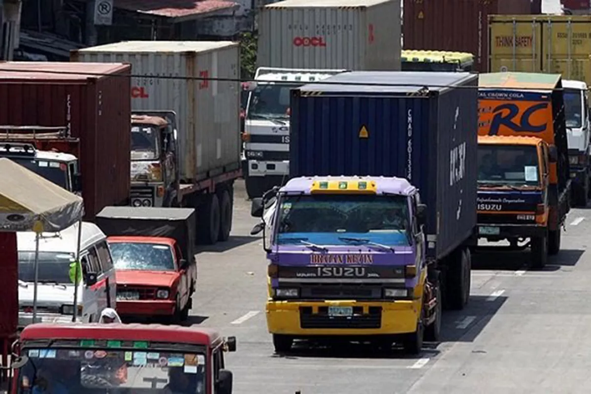 A picture of trucks on a road in Metro Manila