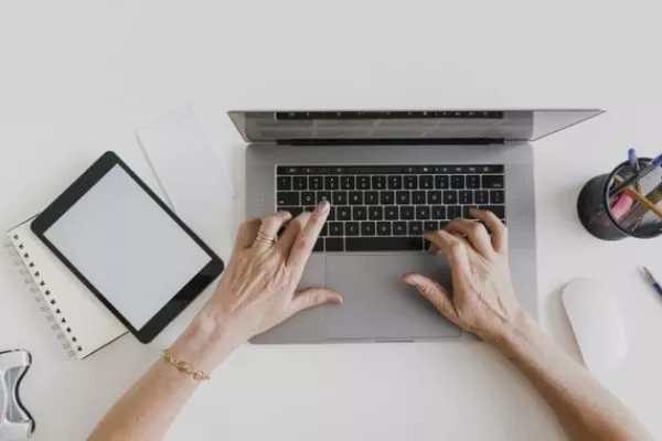 A person typing on a laptop