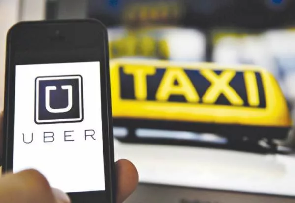 A man using the Uber app on his smartphone