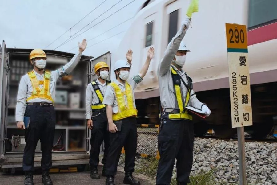 Workers at rail crossing Workers at rail crossing