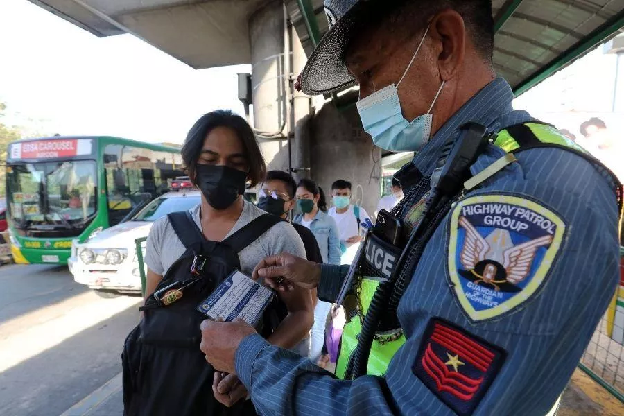 Enforcer inspecting vaccine card Enforcer inspecting vaccine card