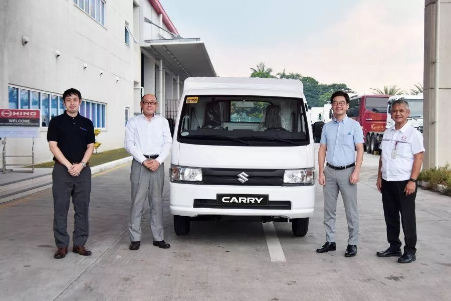 Suzki and Hino officials with Carry