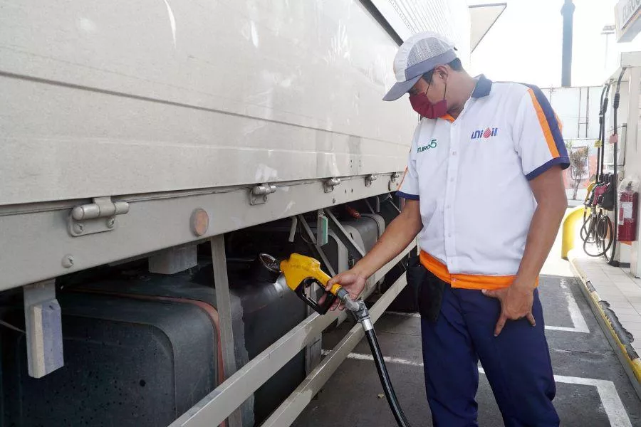 Attendant filling up truck