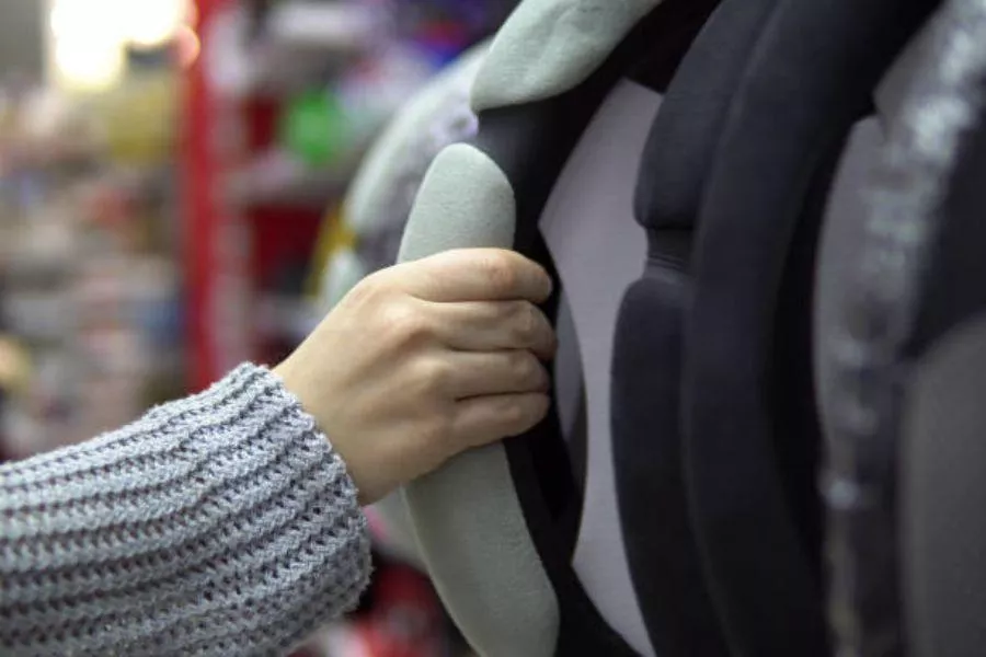 Hand reaching for steering wheel cover