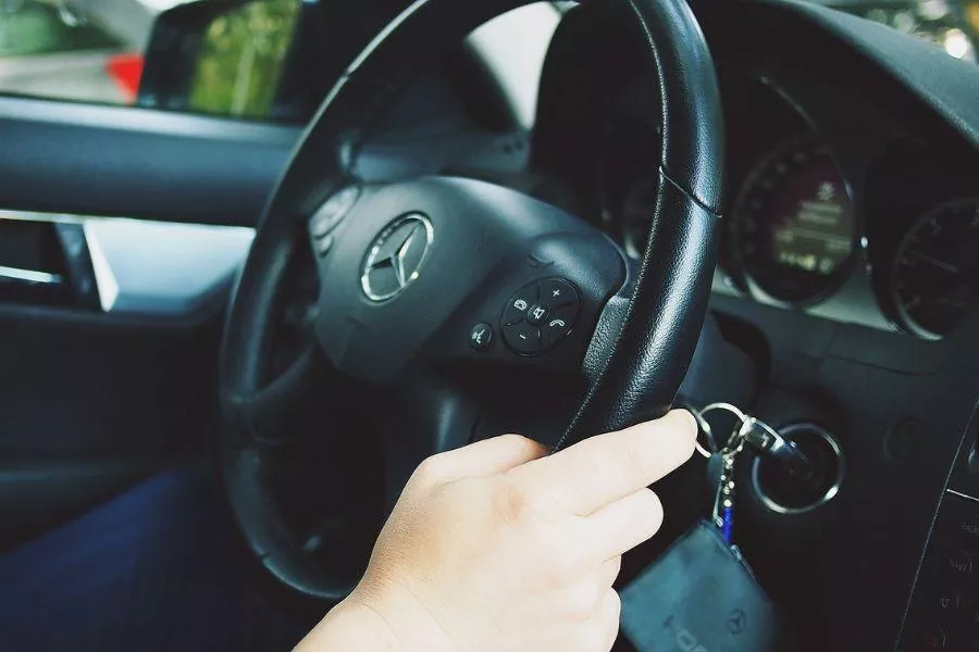 Hand on steering wheel