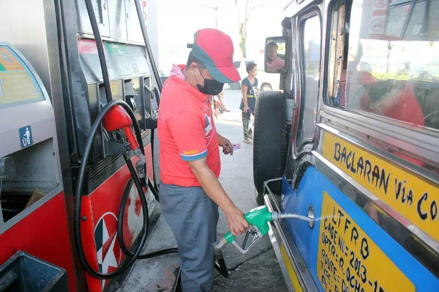 Gas station attendant pumping diesel