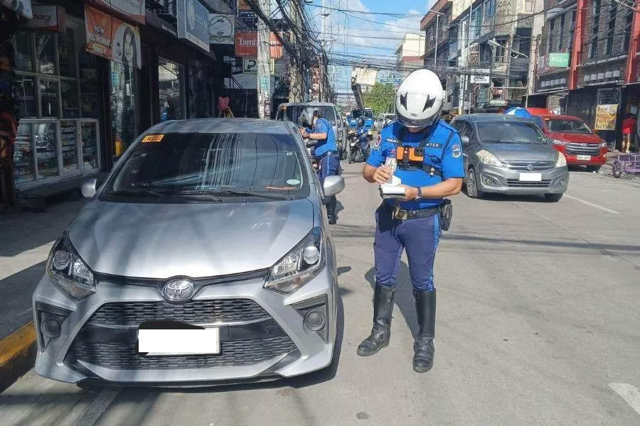 Traffic enforcer writing ticket Traffic enforcer writing ticket