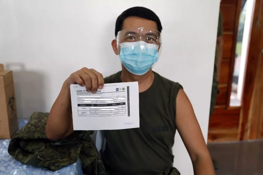 Soldier with vaccination card