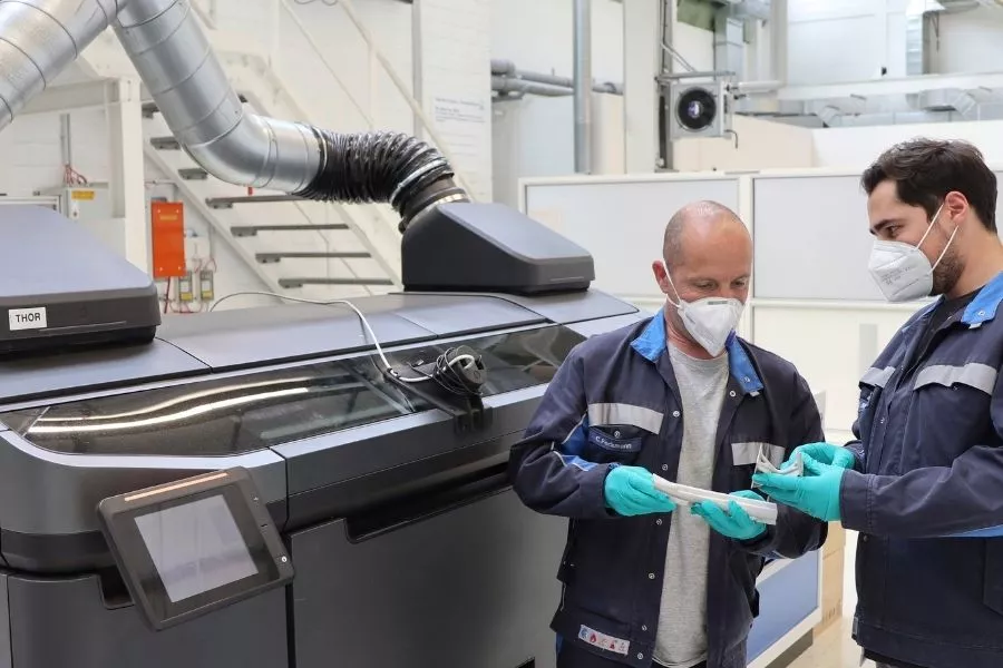 Volkswagen employees using binder jetting printer