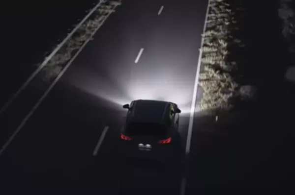 A car traveling on highway at night