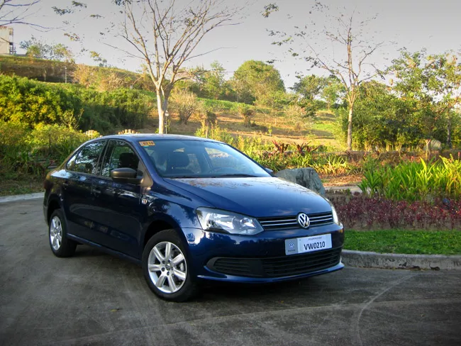 A blue VW Polo sedan angular front view