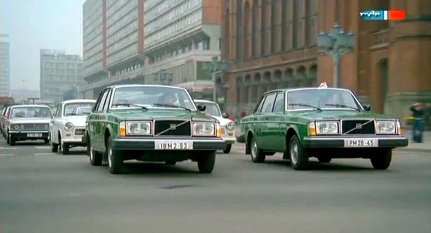 Two Volvo 144s sedan on the road