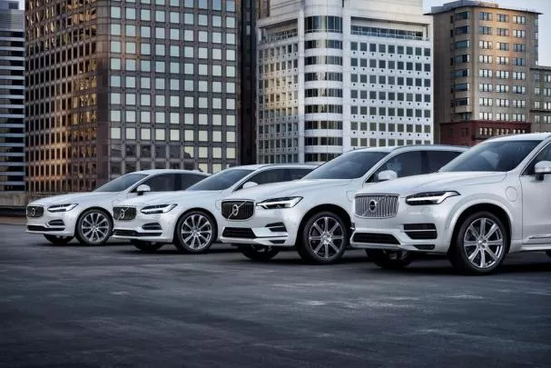 4 white Volvo cars 