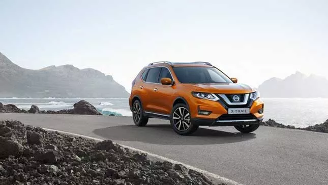 An orange Nissan X-Trail 2018 on the road