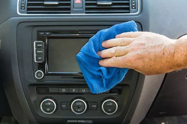 Man cleaning the infotainment touchscreen