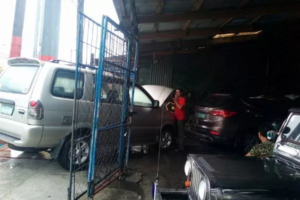 3MT Buenafe's shop on a rainy day A picture of the 3MT Buenafe Car Aircon Service shop