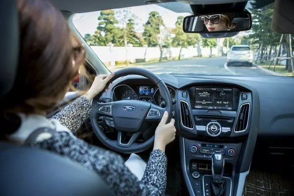 Woman holding a steering wheel