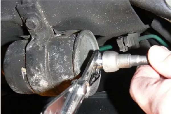 bolt and screw holding the fuel filter