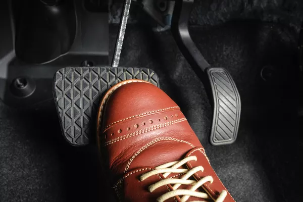 man steeping on the brakes