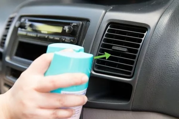 Spraying disinfectant on every vent of your car
