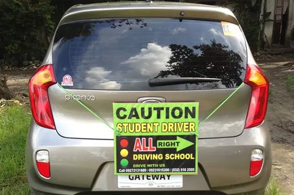 One of Allright Driving's Schools training vehicles with the student driver sign. Allright Driving School Cebu's training unit