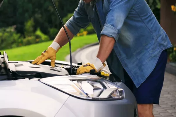 Use a pair of dependable gloves that you can buy at auto-supplies store Man checking the engine