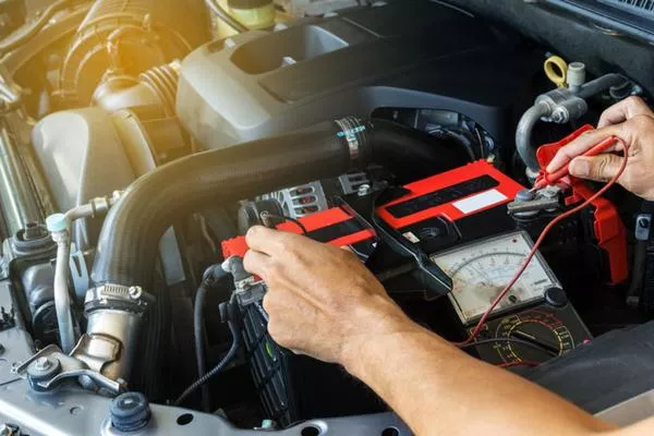 Your car battery is a necessary element when you start your vehicle Man checking the battery