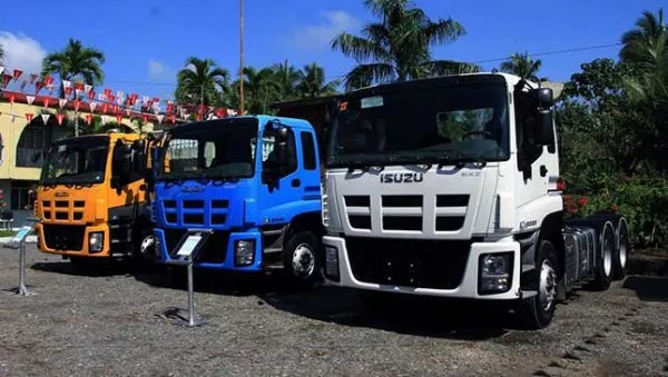 three Isuzu trucks in three different colors