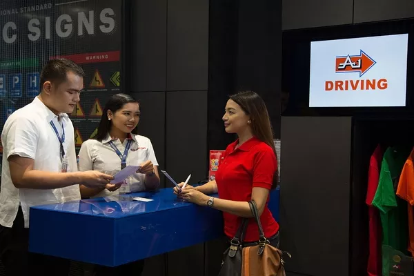 Woman enrolling in driving lessons