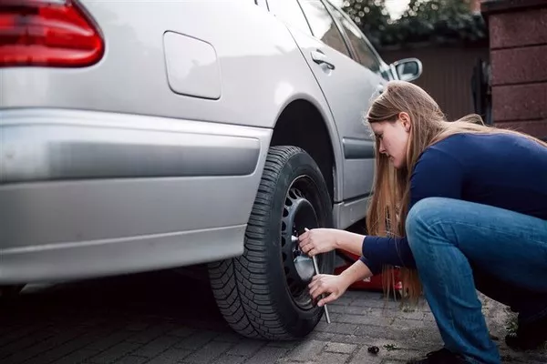 Woman fixing the tire