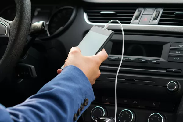 Man holding the phone inside the car