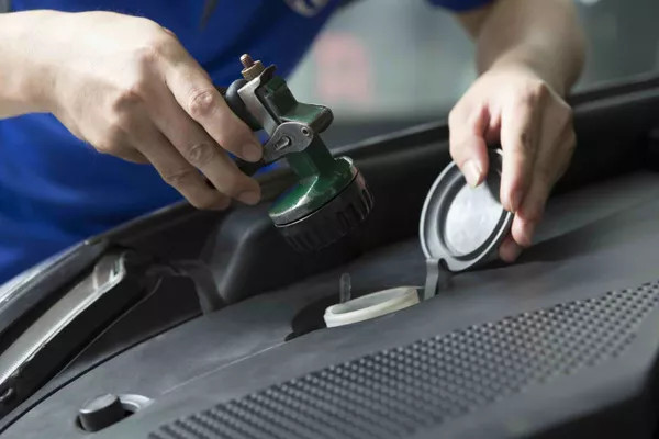 Man checking a part of the engine