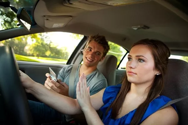 Woman driving with a man in the passenger seat