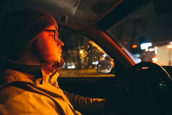 Eyewear at night is no fashion statement but a necessity for safe driving! man driving with glasses