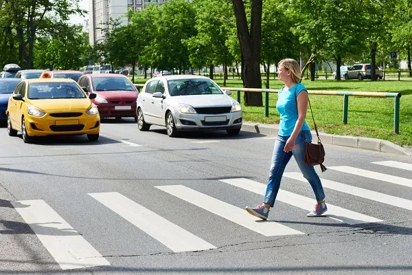 To be safe, pedestrians should only cross busy roads on the right crossing area. pedestrian crossing