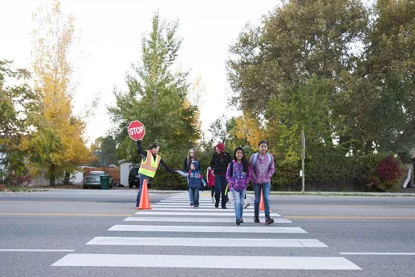 Be mindful of school zones and crossings. Keep an eye out for students who might suddenly cross the street Children cross the street