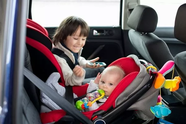 A kid on a rear facing child seat