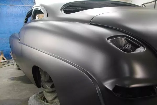 Rear view of a classic car in a paint shop