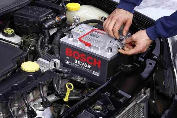 Man handling the car battery