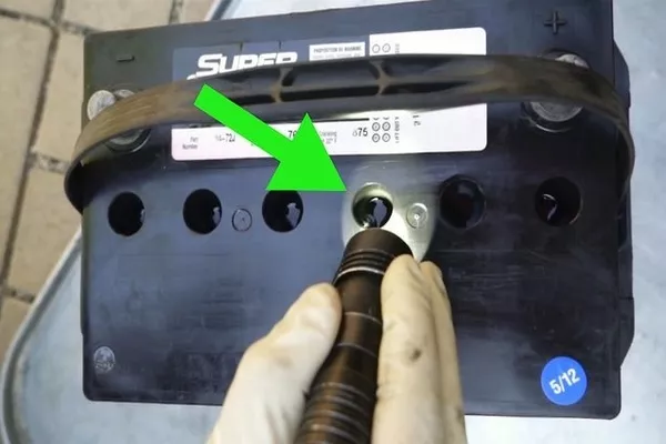 Man checking the water levels on the battery 