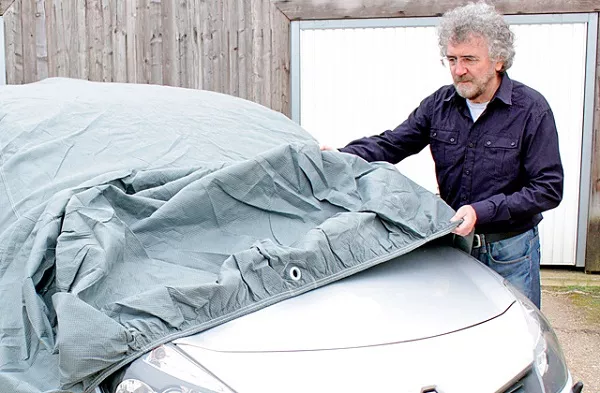 Man covering the car