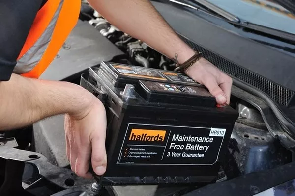 Man holding a car battery