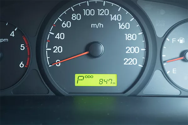 A picture of a new car's odo with mileage