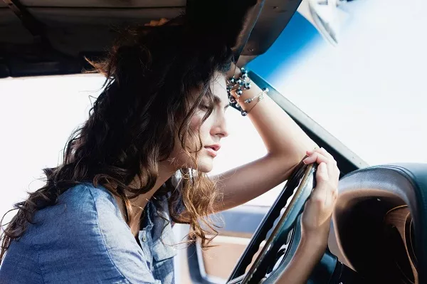 Having a noisy audio car system can be frustrating Frustrated woman in the car