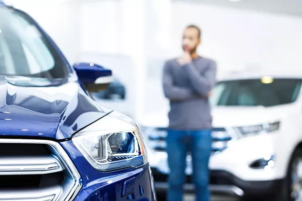 man is buying a car