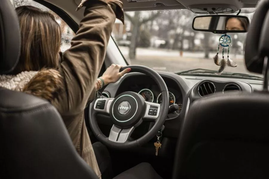 A woman driving a Jeep